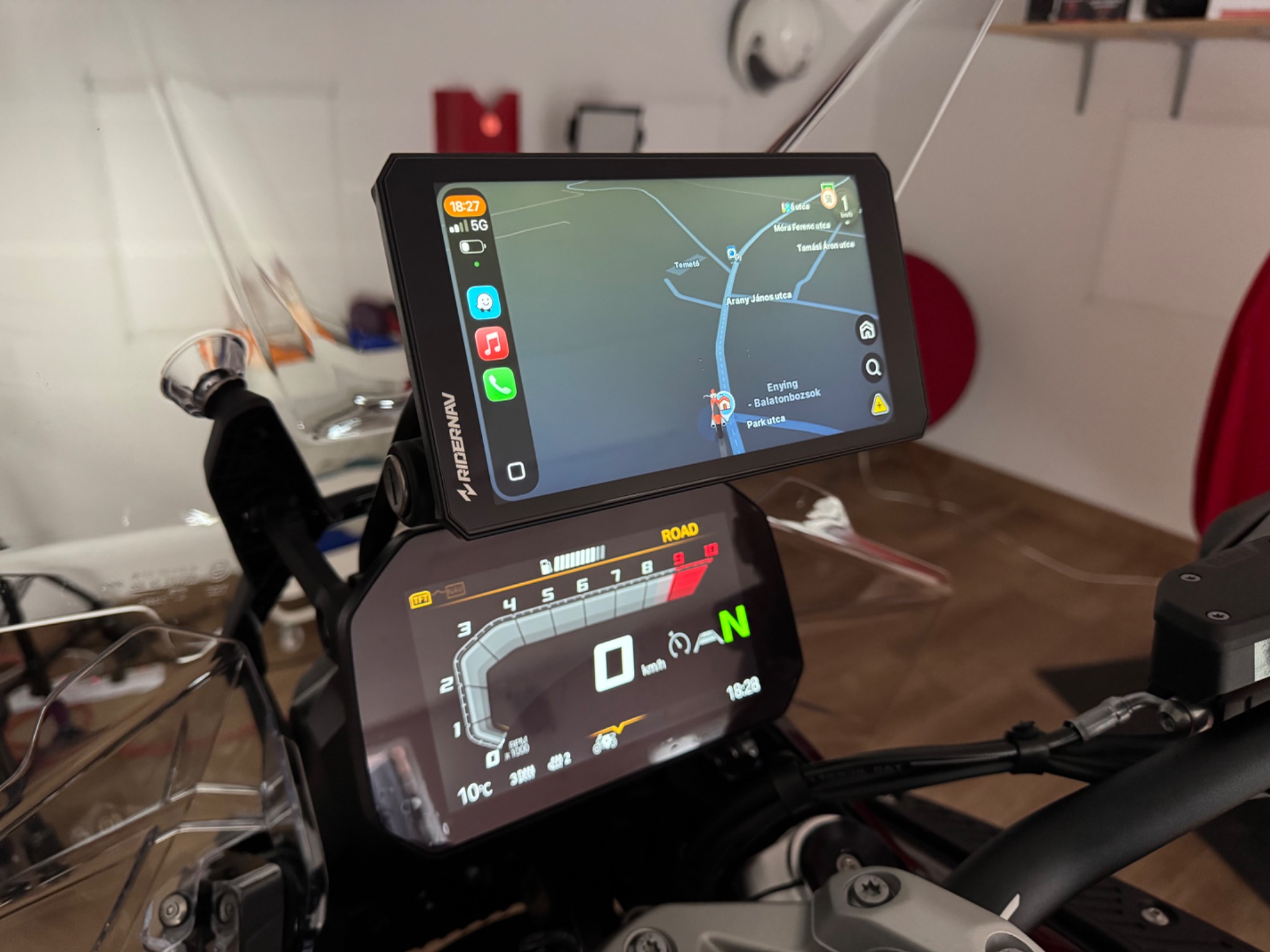 RiderNav R7M mounted above the BMW instrument display in the garage